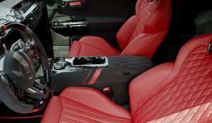Custom Mustang GT interior with red diamond-stitched leather seats, Alcantara armrest, and carbon fiber trim on the dash and console